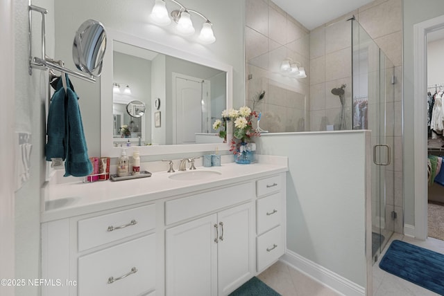 bathroom with vanity, a shower with shower door, and tile patterned floors