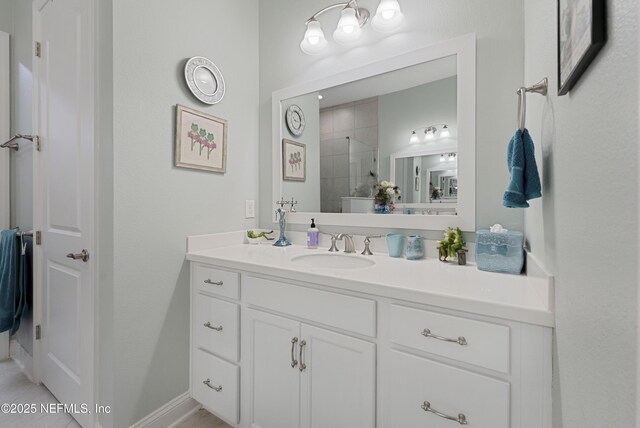 bathroom featuring vanity and a tile shower