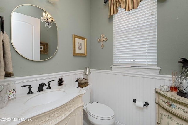 bathroom with vanity, plenty of natural light, and toilet