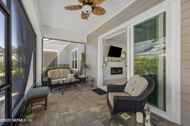 sunroom / solarium with ceiling fan and a wealth of natural light