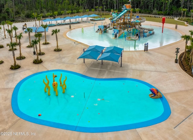 view of swimming pool featuring a playground