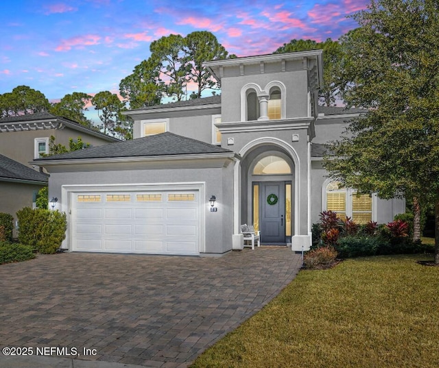 view of front of property featuring a garage and a yard