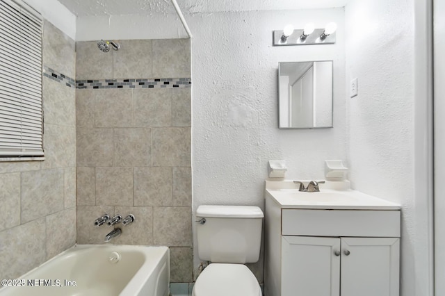 full bathroom featuring vanity, toilet, and tiled shower / bath combo