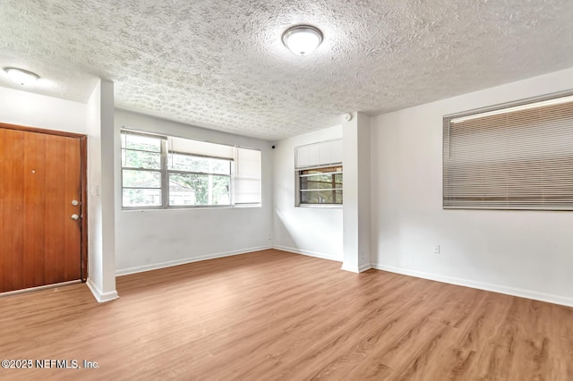 foyer featuring a textured ceiling and light wood-type flooring