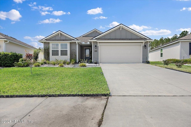 single story home featuring a garage and a front lawn