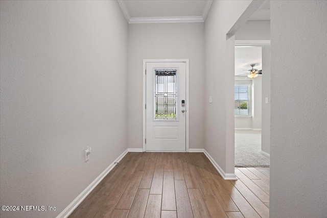 entryway with hardwood / wood-style flooring and ornamental molding