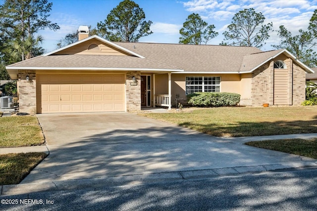 single story home featuring a garage, cooling unit, and a front lawn