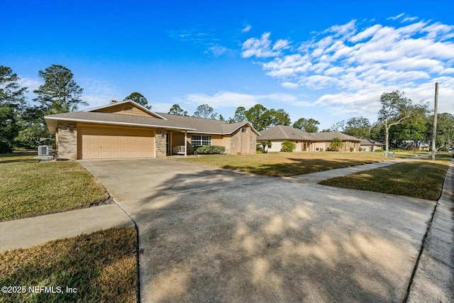 ranch-style house with a garage, a front yard, and central air condition unit