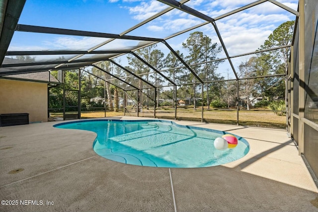 view of swimming pool with a patio and glass enclosure