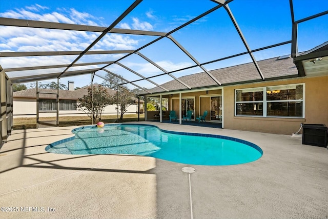 view of pool featuring glass enclosure and a patio area