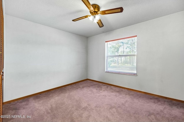 carpeted spare room featuring ceiling fan and a textured ceiling