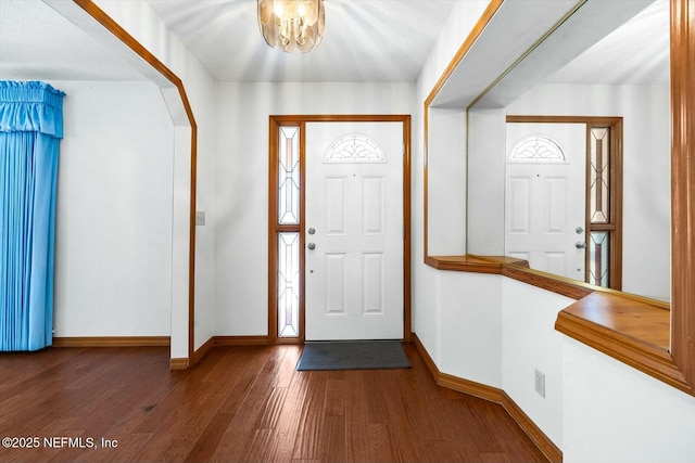 foyer entrance featuring hardwood / wood-style floors and a chandelier