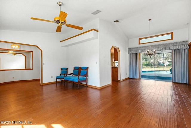 interior space featuring ceiling fan with notable chandelier, high vaulted ceiling, and dark hardwood / wood-style floors