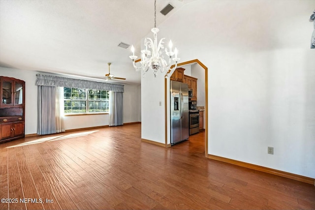 interior space with ceiling fan with notable chandelier, wood-type flooring, and vaulted ceiling