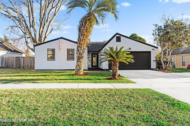 ranch-style house featuring a garage and a front yard