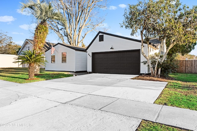 ranch-style home with a garage and a front yard