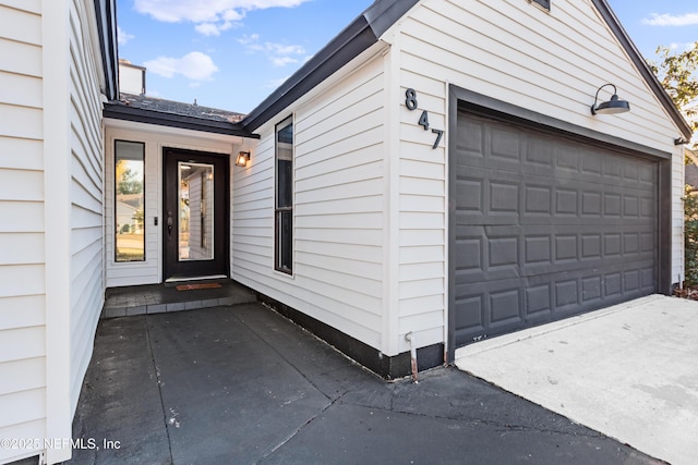 doorway to property with a garage