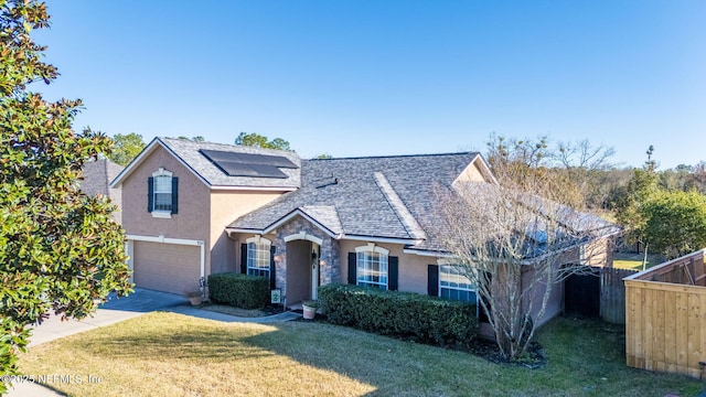 front of property featuring a front lawn and a garage