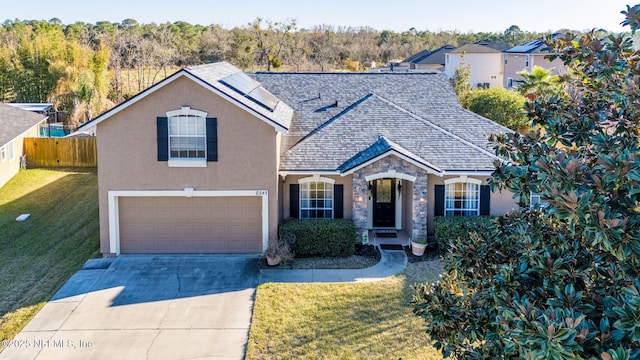 view of front of home featuring a garage and a front lawn