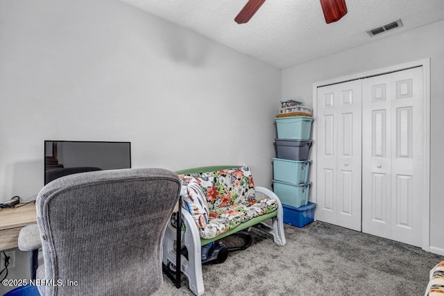 office featuring ceiling fan, carpet floors, and a textured ceiling