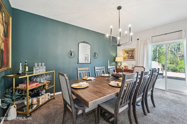 dining room featuring a chandelier, carpet floors, and a textured ceiling