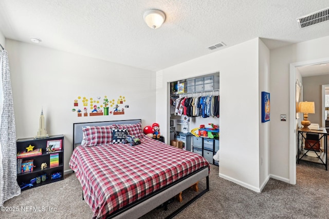 carpeted bedroom featuring a closet and a textured ceiling