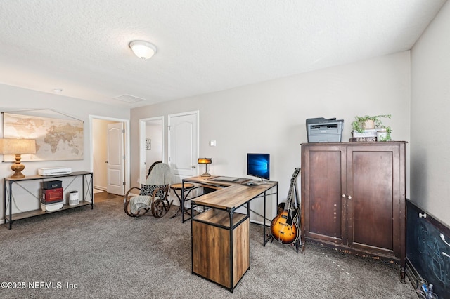 carpeted office space with a textured ceiling