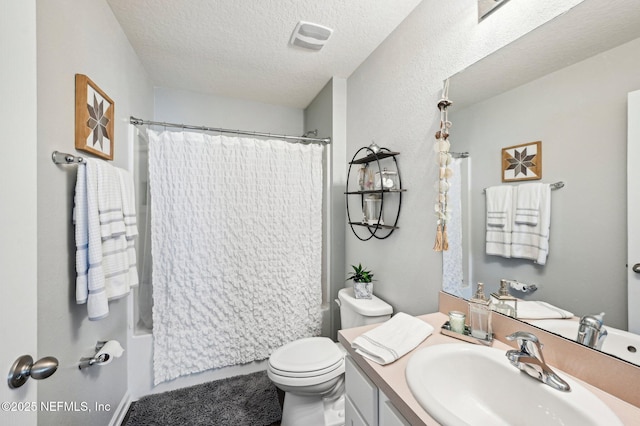 full bathroom featuring shower / bathtub combination with curtain, vanity, toilet, and a textured ceiling