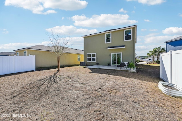 back of property with central air condition unit and a patio area