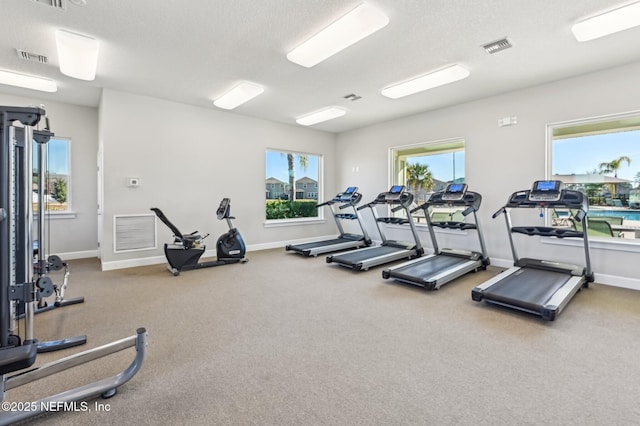 gym featuring a textured ceiling