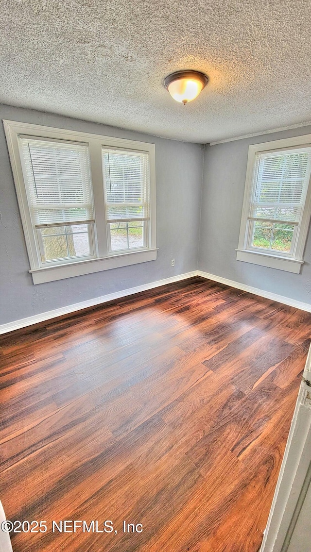 unfurnished room with a textured ceiling