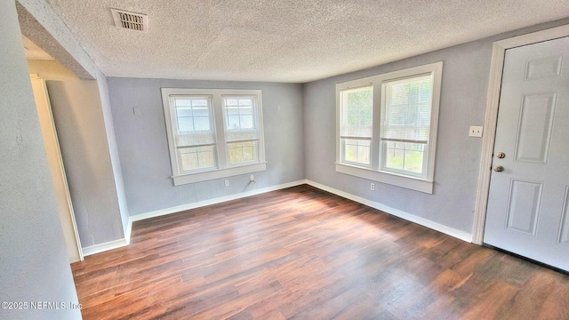 entrance foyer featuring dark hardwood / wood-style flooring and a textured ceiling