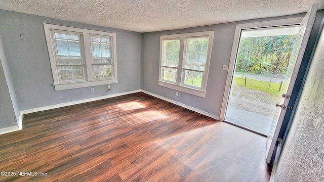 interior space featuring dark hardwood / wood-style floors and a textured ceiling