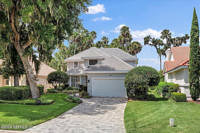 front facade with a garage and a front yard