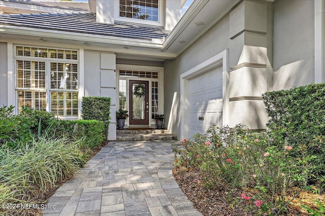 view of exterior entry featuring a garage