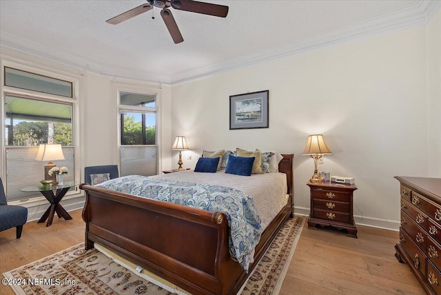 bedroom with crown molding, light hardwood / wood-style flooring, a textured ceiling, and ceiling fan