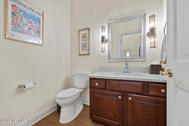 bathroom featuring hardwood / wood-style flooring, vanity, and toilet