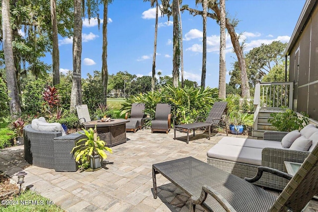 view of patio featuring an outdoor living space with a fire pit