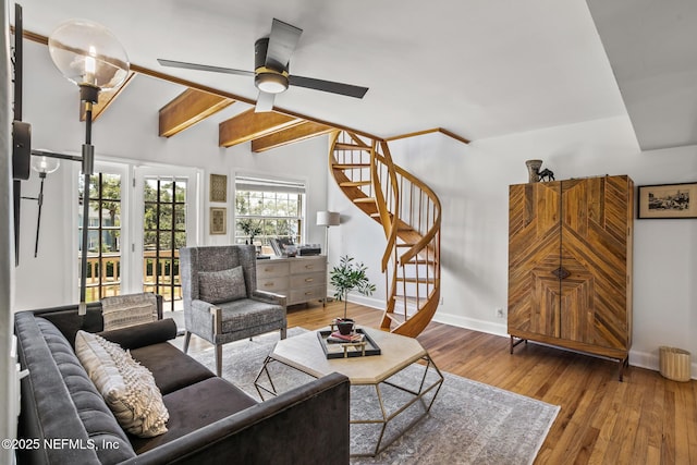 living room with vaulted ceiling with beams, hardwood / wood-style floors, and ceiling fan