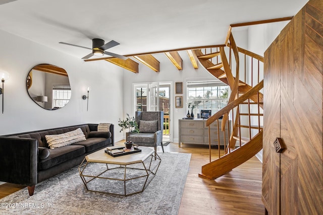 living room with lofted ceiling with beams, hardwood / wood-style floors, and ceiling fan