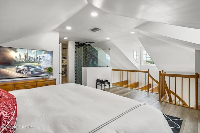 bedroom with lofted ceiling and light hardwood / wood-style flooring