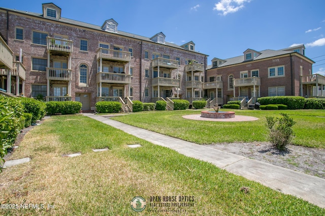 view of property's community with a lawn