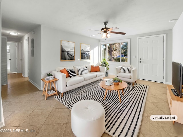 living room featuring light tile patterned floors and ceiling fan