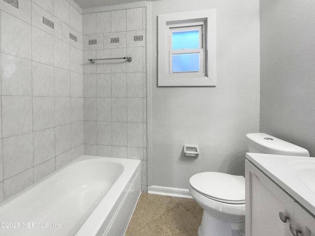 full bathroom featuring tile patterned flooring, vanity, tiled shower / bath, and toilet