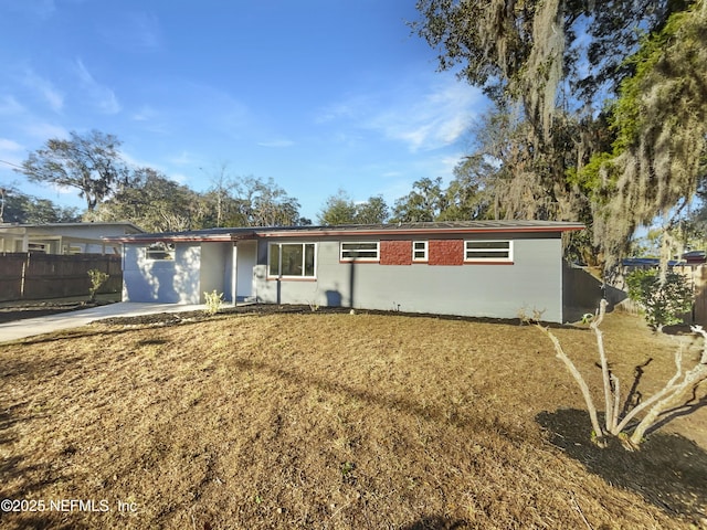 ranch-style house with a front lawn