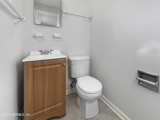 bathroom featuring tile patterned floors, vanity, and toilet