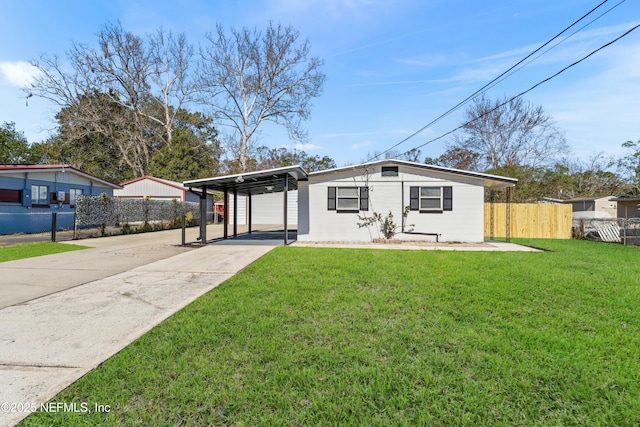 ranch-style house featuring a front lawn and a carport