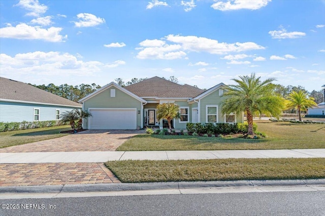 ranch-style house featuring a garage and a front lawn