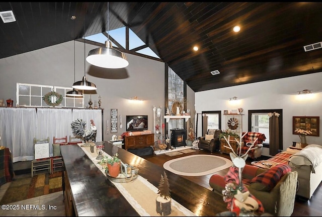 dining space with wood ceiling and high vaulted ceiling