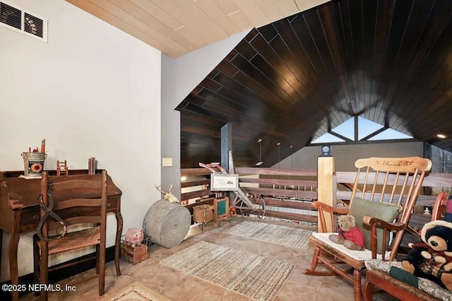 living area featuring vaulted ceiling and wooden ceiling